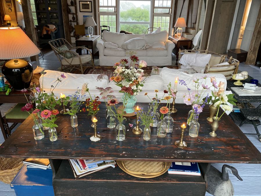 Bud vases in a long row of tiny bottles