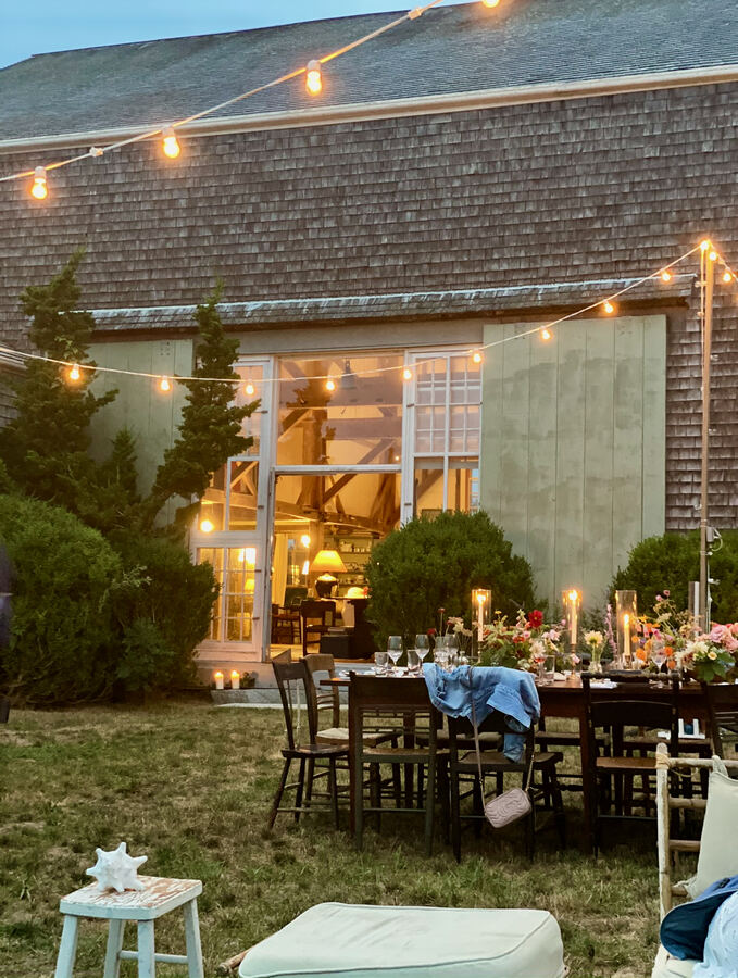 Martha's Vineyard: table by the shingled house with string lights