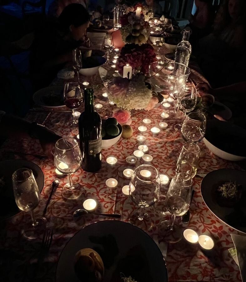 Candlelit birthday table at night, Île de Ré, red cloth, hydrangeas